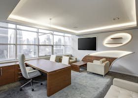 Sleek office space featuring contemporary furniture and city skyline views, ideal for professionals.